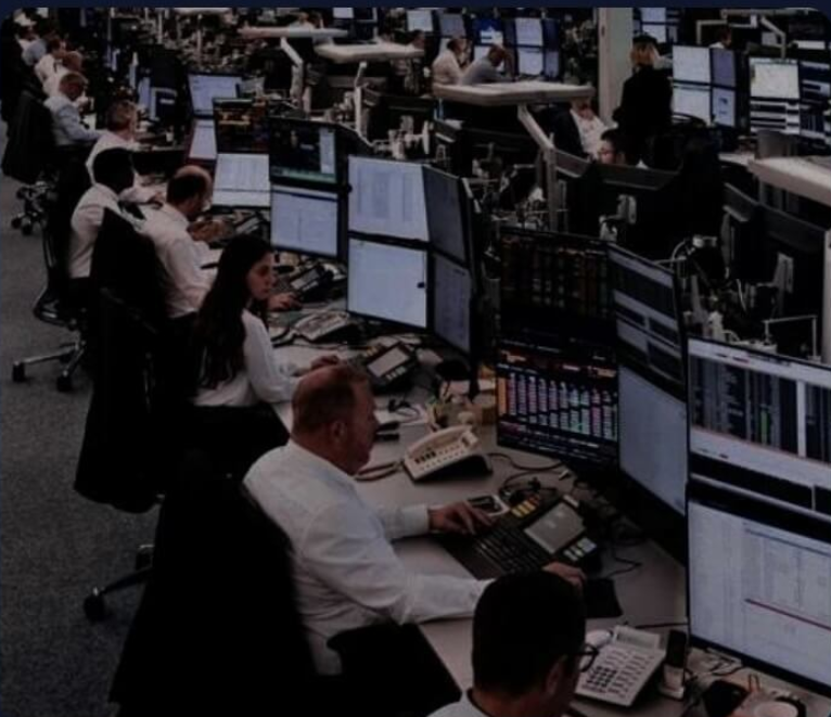 Trading floor with multiple desks and monitors